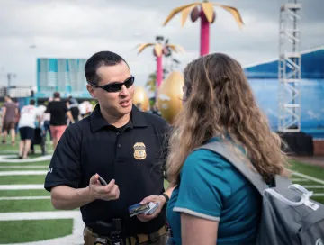 Homeland Security Investigations agent talking to a student