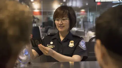 CBP officer checking passport.
