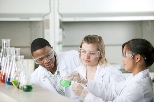 People working with chemicals in a lab.