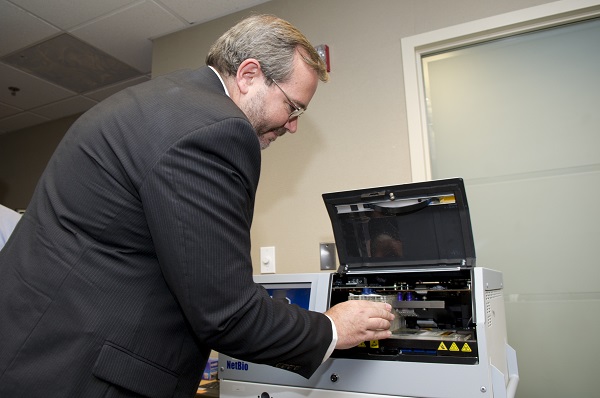 S&T Program Manager, Chris Miles, loads the Rapid DNA machine.