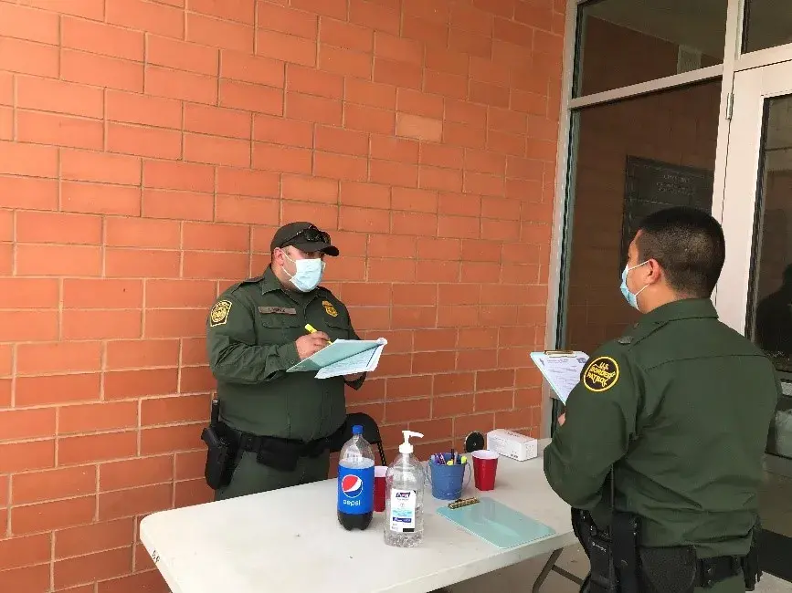 CBP Officer Perez checking in CBP Officer Flores at the Laredo vaccination event.