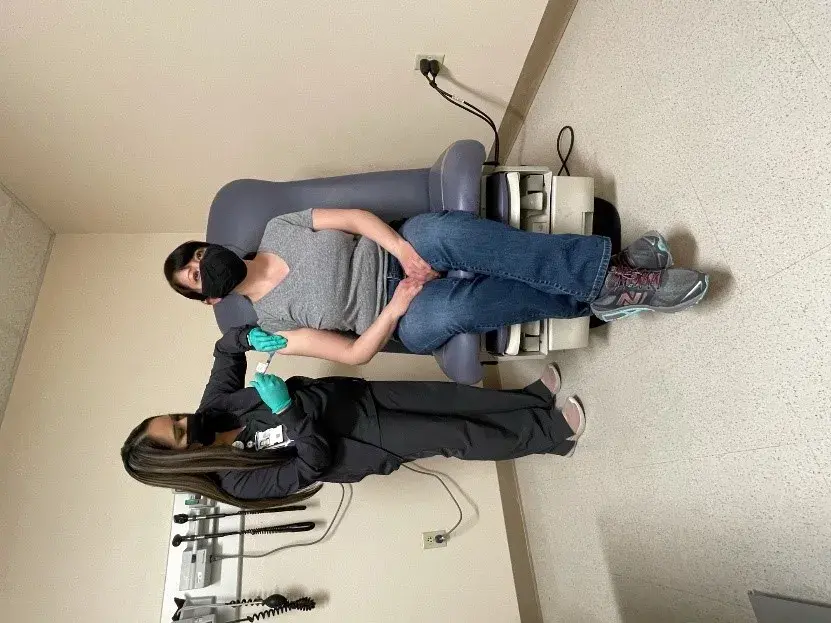 Teresa Silva, Supervisory Import Specialist, Centers of Excellence and Expertise, assigned to Los Angeles Field Office, receiving a COVID-19 vaccination at the El Paso VA Medical Center