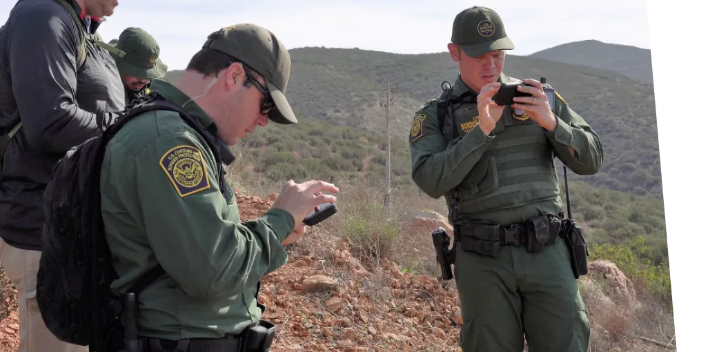Border agents using hand held devices.