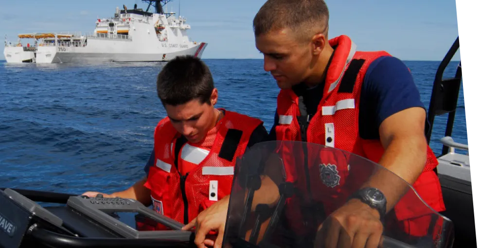 Agents on a boat using a hand held technology.