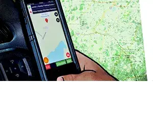 A hand holding a smartphone with a map on the screen