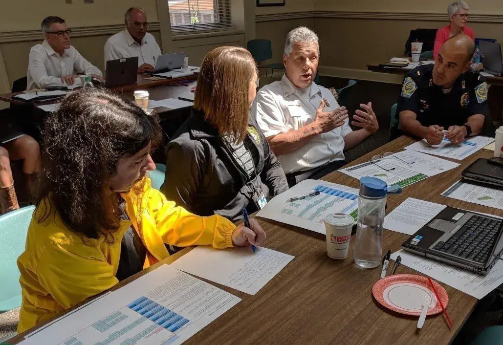 Nashua, N.H., community members discuss the scoring and geographic placement of a policy as part of a Plan Integration for Resilience Scorecard (PIRS) activity.