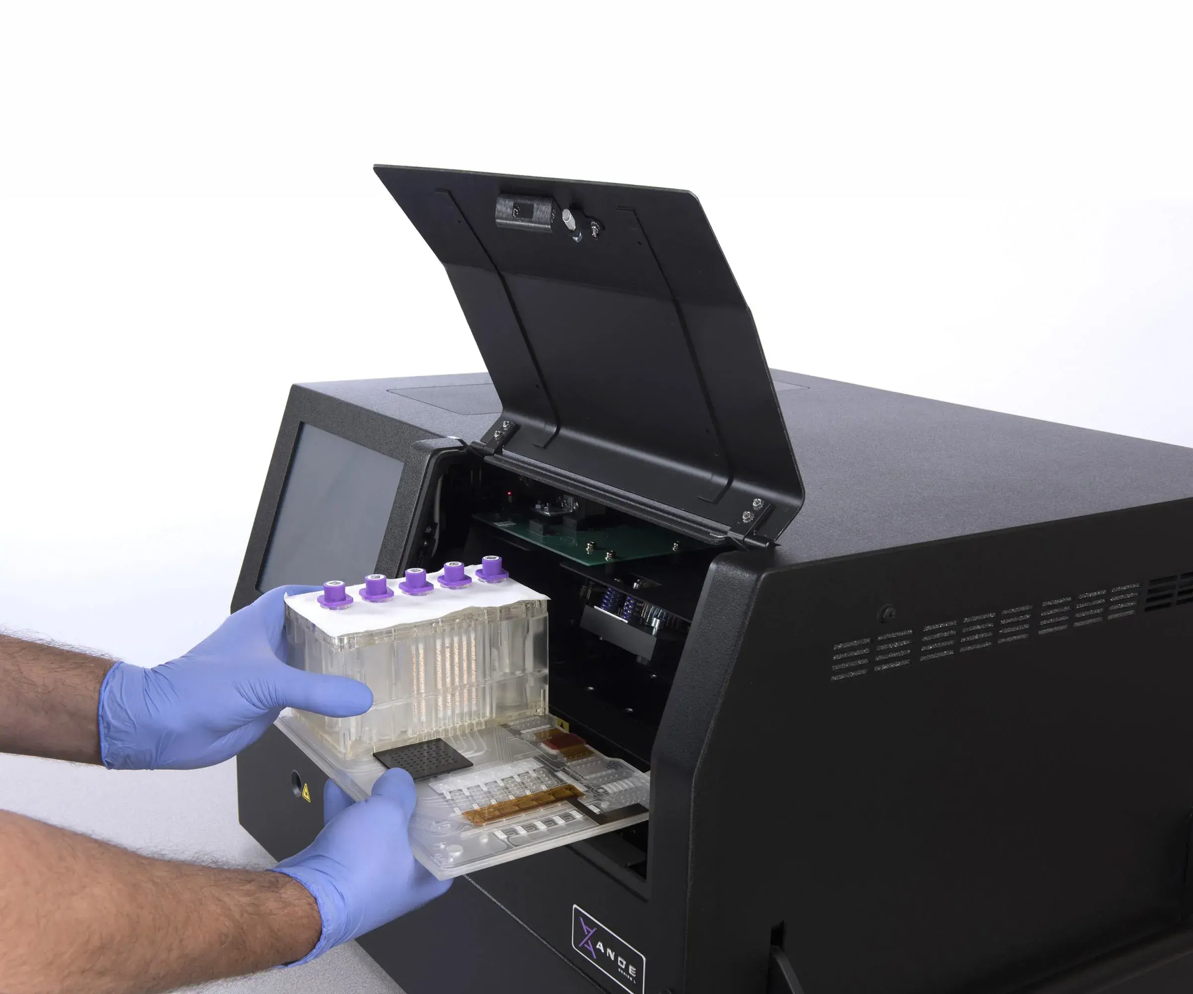 ANDE’s Rapid DNA machine can analyze five DNA samples at a time. Here the BioChip with test tubes is being inserted. Image by ANDE Corporation.
