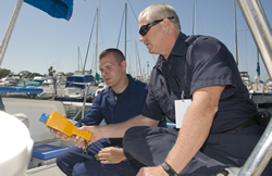 Two officers checking nuclear security on a boat.