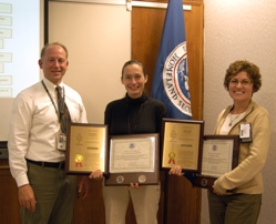 Adam Hutter, Director of NUSTL, presents Cecilia Murtagh (center) and Gladys Klemic with plaques commemorating DHS’s first patent.  Not pictured: co-investigator Paul Bailey, now at the University of Maryland. (Jenny May)