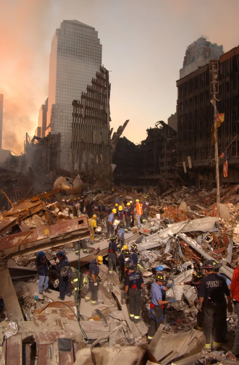 Image: 9/11 -  Fire fighters and Urban Search and Rescue teams work amidst the rubble