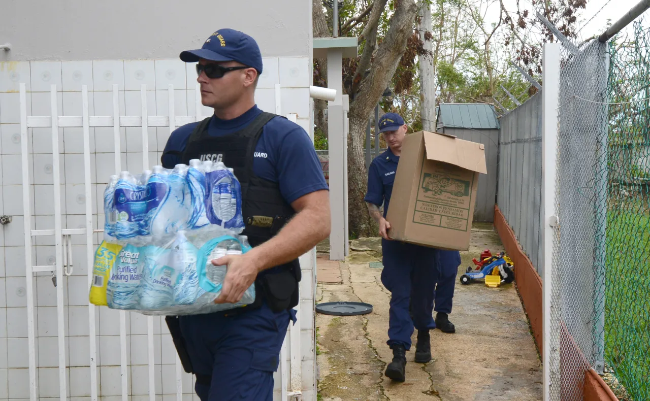 Image: Petty Officer 3rd Class Dan Wakeman Coast Guardsmen deliver donated food, water and other aid to orphanage in Isabela, Puerto Rico