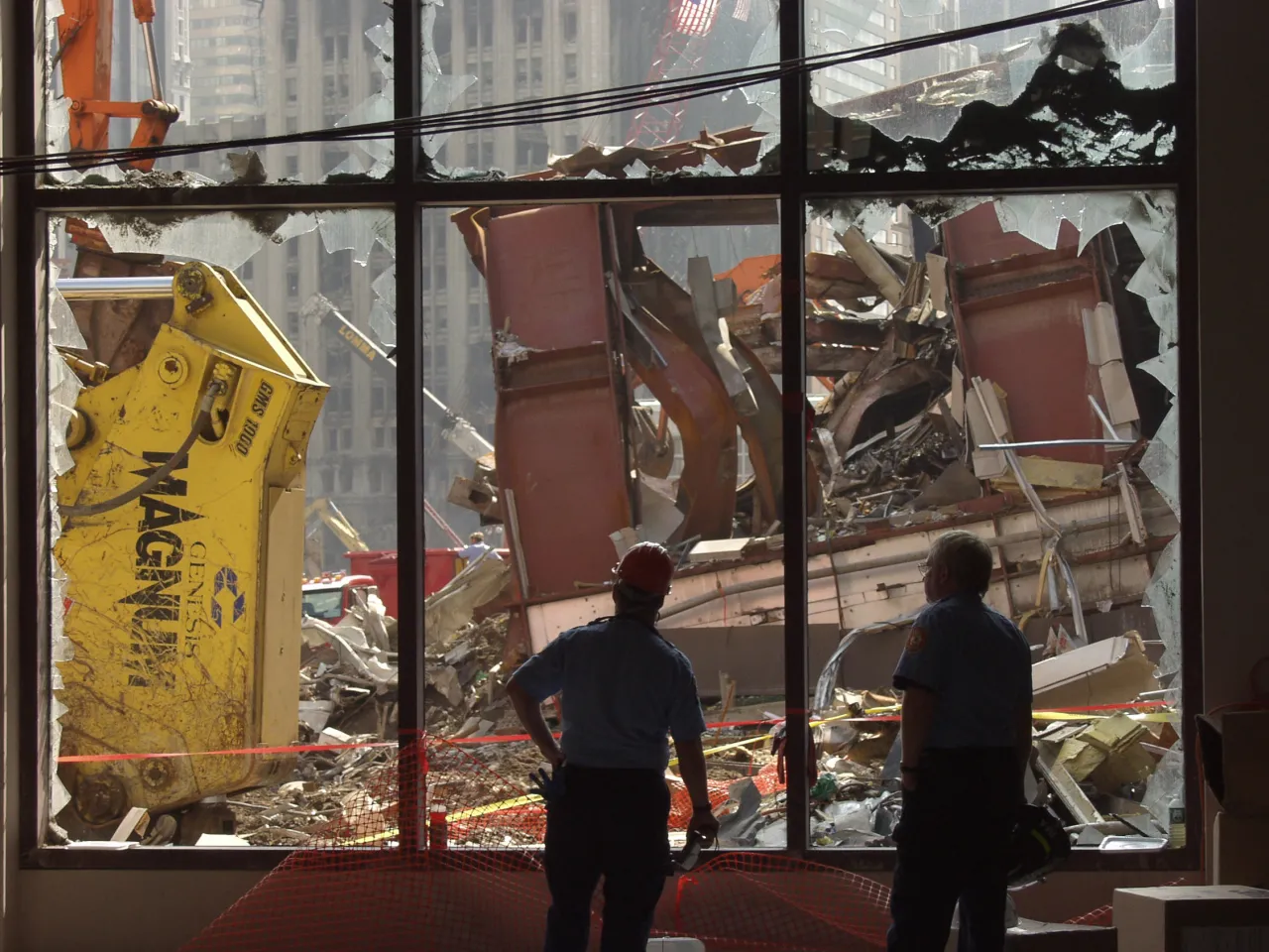 Image: 9/11 - Officials look through shattered windows of cleanup operations at Ground Zero