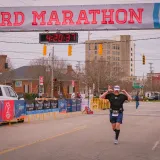 Image: Runner finishes the Coast Guard Marathon