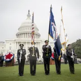 Image: Five DHS Officers Hold Flags and Shotguns in Front of the U.S. Capitol