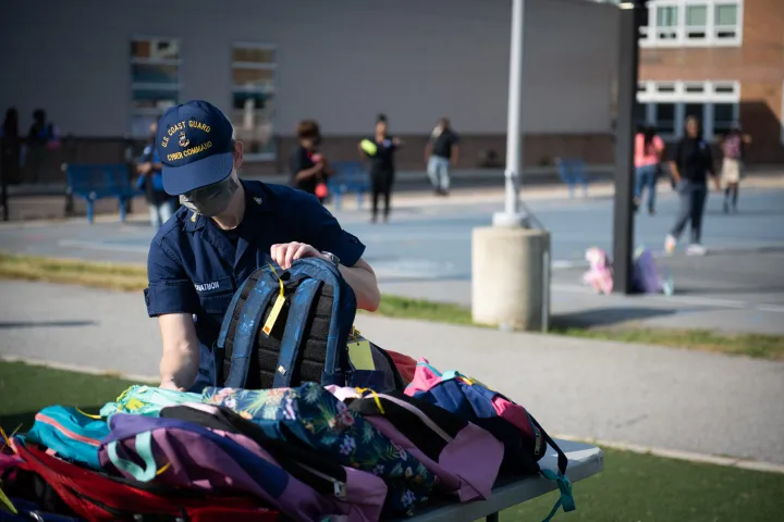 Cover photo for the collection "Coast Guard Members Distribute Backpacks at Turner Elementary School"