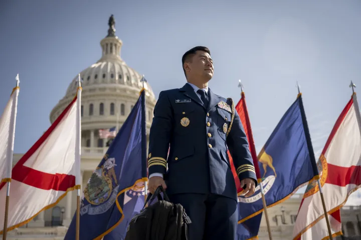Image: Officer in front of the U.S. Capitol and a Line of Flags