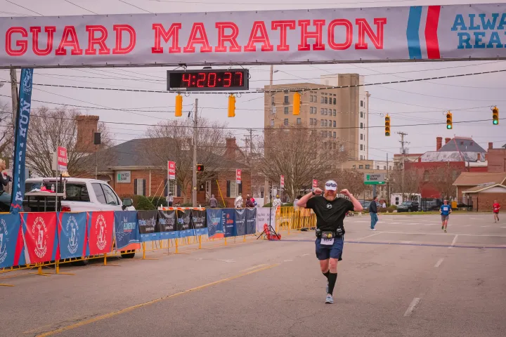 Image: Runner finishes the Coast Guard Marathon