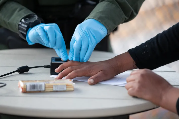Image: U.S. Border Patrol Agent Takes Fingerprints