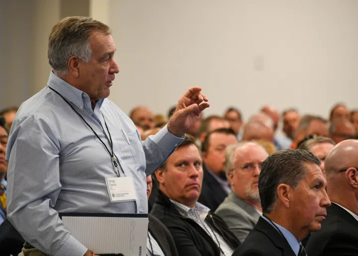 Image: Man Asking Question at Corporate Security Symposium