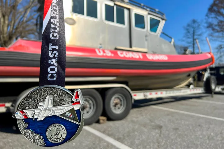 Image: Coast Guard Marathon Medal with a Special Purpose Craft Law Enforcement boat.