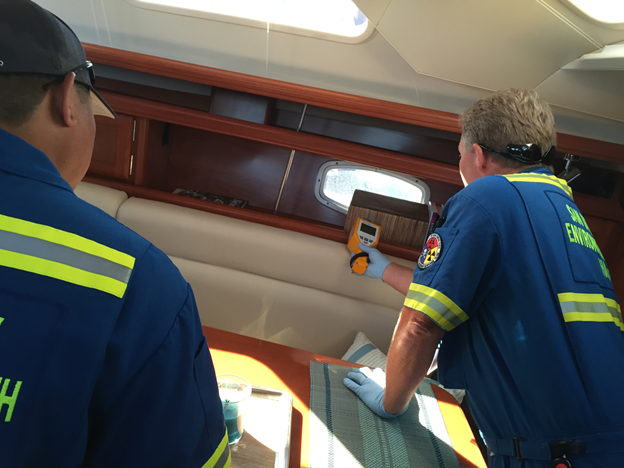 Participants from the San Diego County Department of Environmental Health are shown using a radioisotope identification device to identify the radiological and nuclear material of concern on a maritime vessel as part of one of the assessment’s scenarios.
