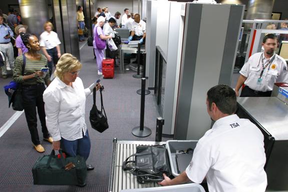 Travelers going through secuirty at the airport