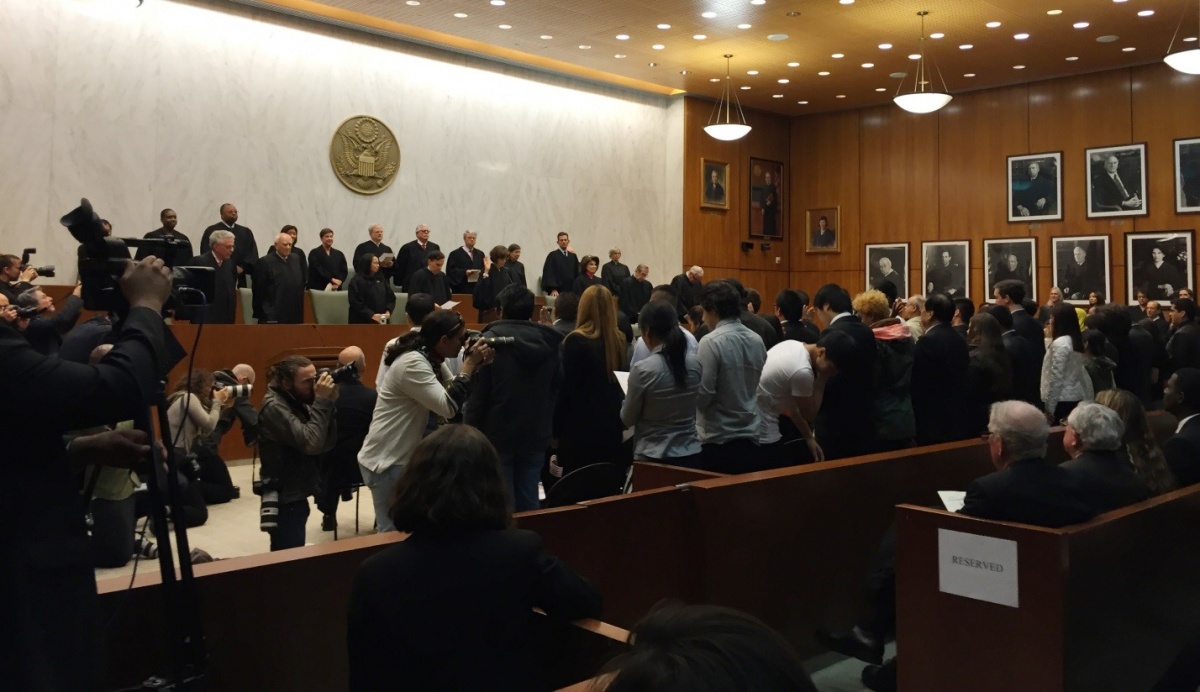 Judges watch as naturalization candidates prepare to take the Oath of Allegiance at the U.S. District Court for the Eastern District of New York in Brooklyn.