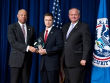 Officer Cronen receiving award from Secretary Johnson