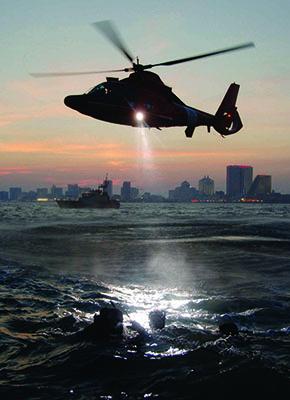 USCG helicopter hovering over water