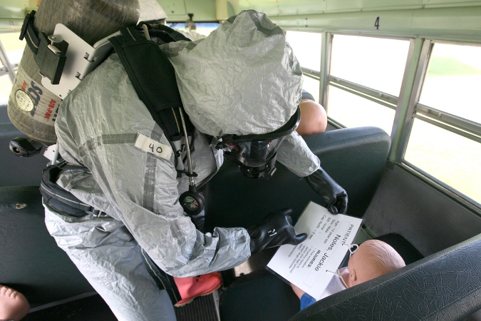Responder training - responder on a bus reviewing patient's symptoms