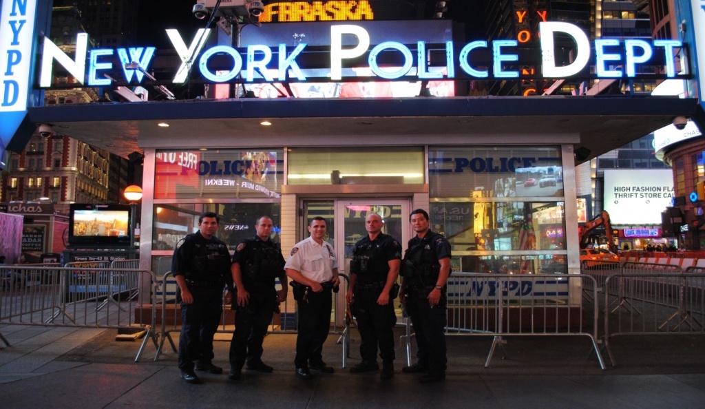 Captain Dan Dooley (white uniform) and an Emergency Service Unit stand outside their Times Square outpost in New York City.