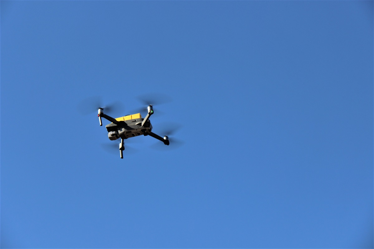 A DJI MAVIC 2 drone flying in the sky.