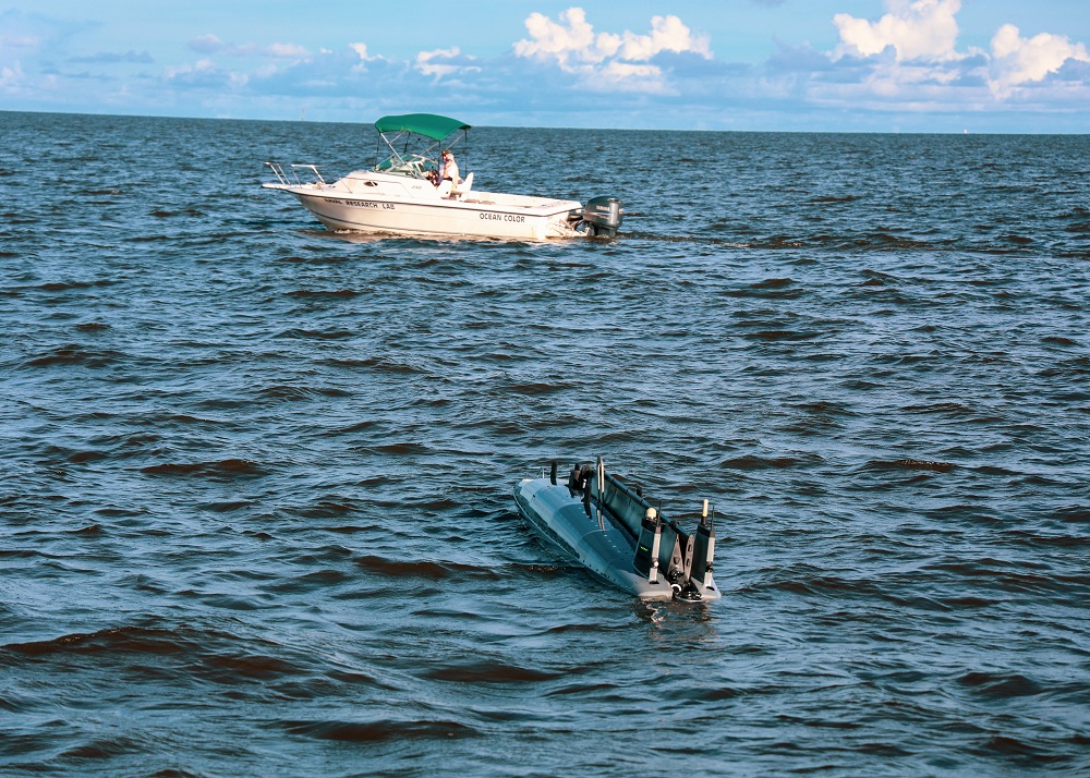 S&T, USCG, Ocean Aero, CNSP, NRL, ARL, HSSEDI, and USM’s evaluation team monitors an autonomous Triton vessel from a motorboat as it undergoes testing in the waters off Gulfport, MS. 