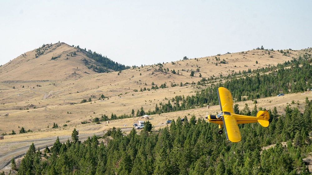 A Super Cub aircraft pilot conducts a mid-day flight over the mountains to see if he will be detected by the equipment being tested. 