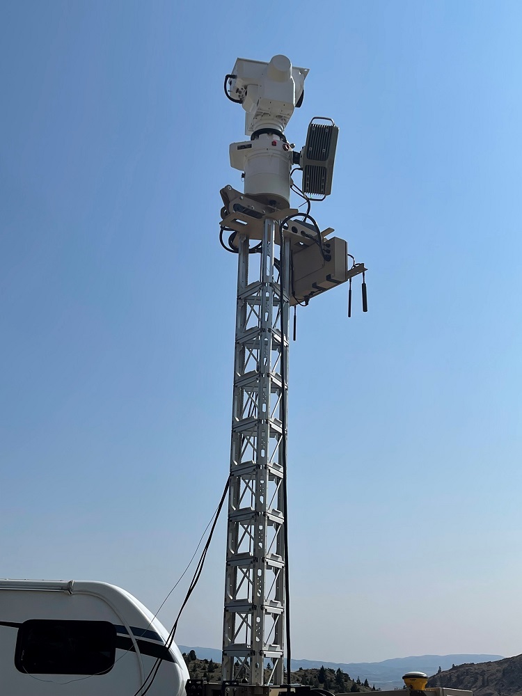A tower equipped with an electro-optical/infrared camera, X band radar, and passive radio frequency system stands in a field at Limestone Hills – ready to detect, track, and identify drones and planes that fly by during testing. 