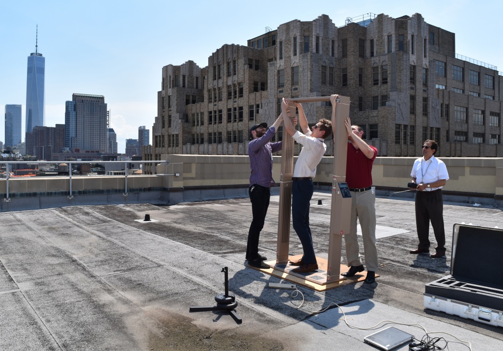 Four men set up a RAD portal on the roof of a building
