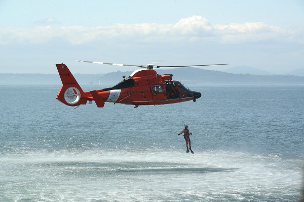A Coast Guard aircrew performs  a search and rescue demonstration off the coast of Seattle, WA.
