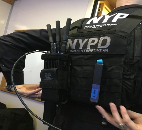 An NYPD officer wearing a component of MANET on his back.