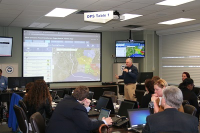 At the FRG flood experiment, an operations officer leads the group through scenarios.