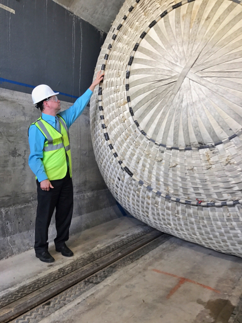 tunnel plug inflates in a tunnel. John Fortune stands beside it.