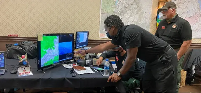 Fire managers in California Incident Management Team 4’s Situation Unit reviewing helicopter video footage of the Caldor Fire using the ATAK app.