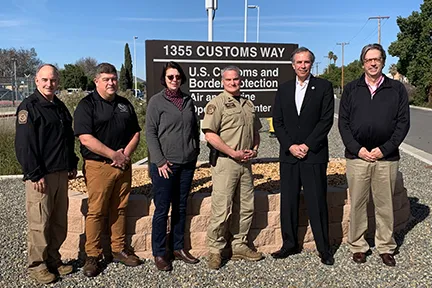 Under Secretary for Science and Technology Dimitri Kusnezov, with David Taylor, Jim Small, Dr Laura Parker and the Customs and Border Protection Air and Marine Operations Center (AMOC) director and staff in front of the CBP AMOC in Riverside, CA.