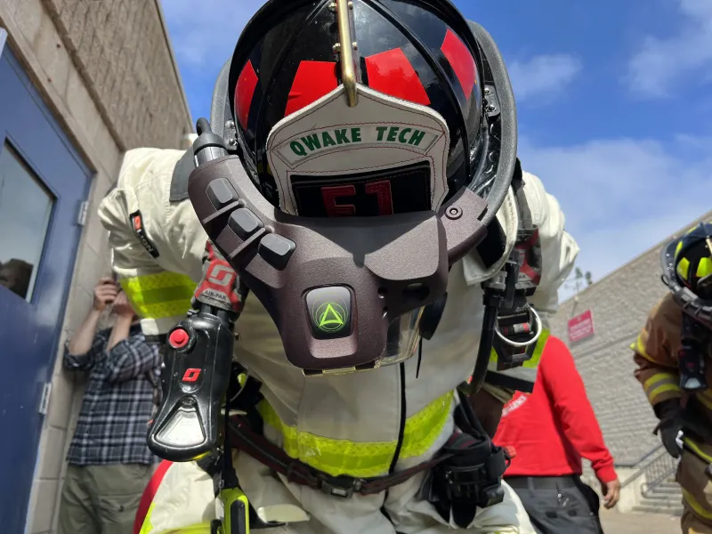 Firefighter displays the ergonomic C-THRU device atop their helmet.