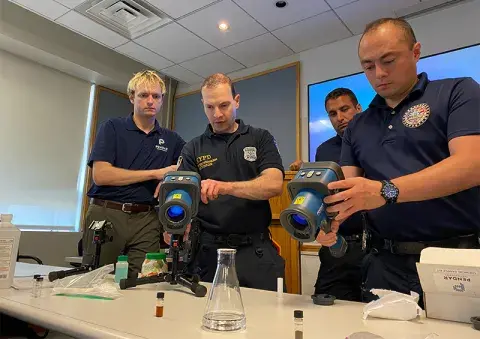 Four first responders using the Pendar Technologies and demonstrating a point-and-shoot Raman system 