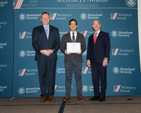 Left to right: U.S. Secret Service Director James Murray, Team Excellence Award recipient Andrew Tran, and DHS Secretary Alejandro Mayorkas.
