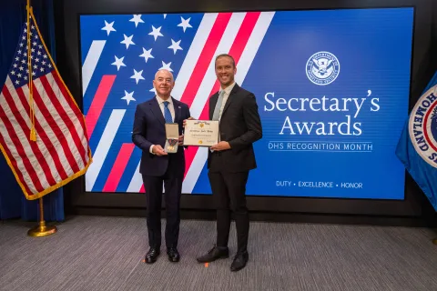 DHS Secretary Alejandro Mayorkas and Secretary's Gold Medal recipient Christopher Wright.