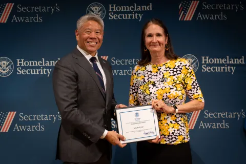 DHS Deputy Secretary John Tien with Team Excellence Award recipient, Maura Busch.