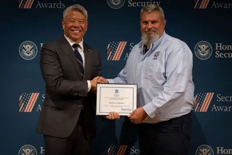 DHS Deputy Secretary John Tien with Leadership Excellence Award recipient, Timothy P. Robinson.