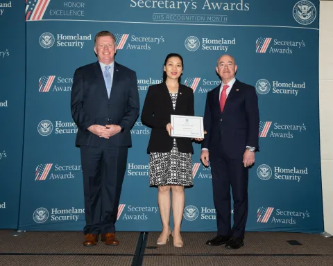 Left to right: U.S. Secret Service Director James Murray, Team Excellence Award recipient Lingping Kong, and DHS Secretary Alejandro Mayorkas.