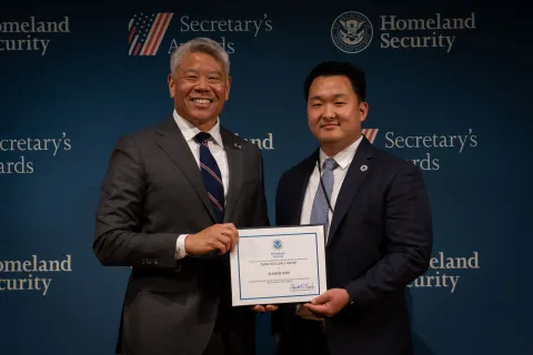 DHS Deputy Secretary John Tien with Team Excellence Award recipient, Eugene Mok.
